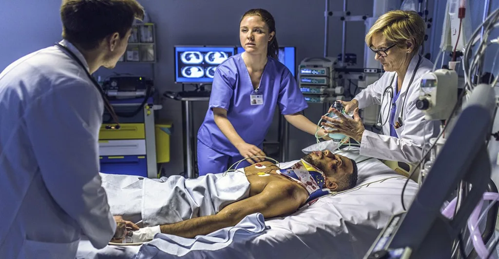 Emergency room nurses working on a patient