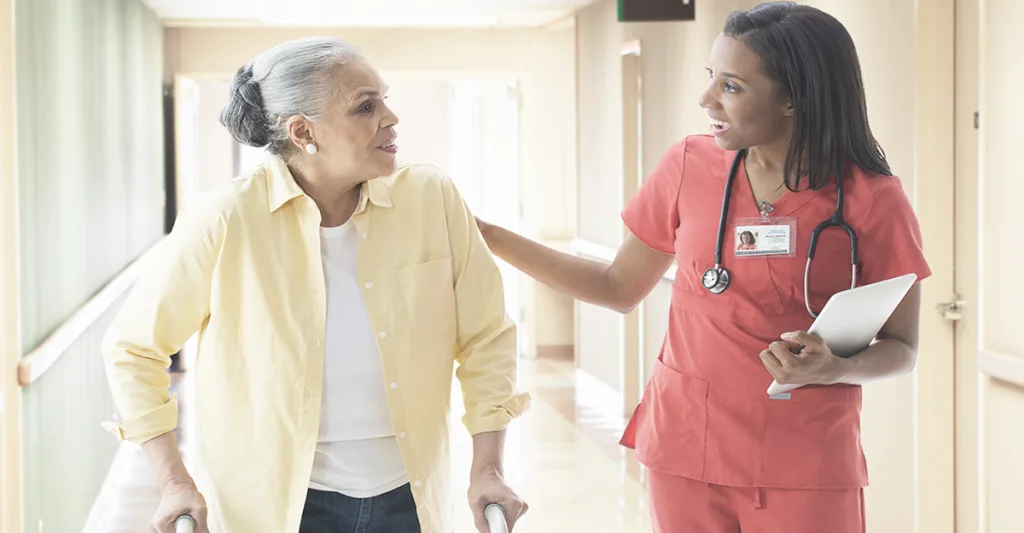 Nurse-in-orange-scrubs-with-patient-FB-GettyImages-519517871.jpg