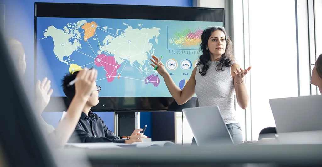 Woman speaking in front of a map