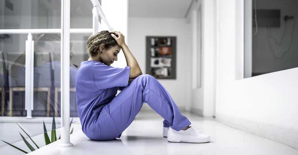 A nurse shows stress from burnout