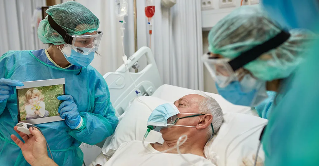 Patient showing his nurse pictures of his family