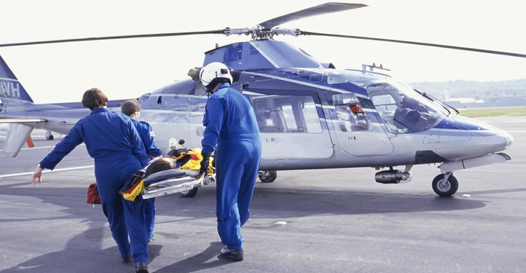 Flight nurses taking a patient on to a helicopter