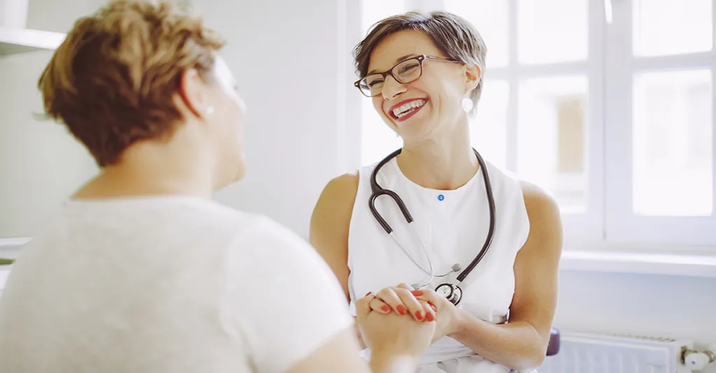 Nurse-with-stethoscope-laughing-with-patient-FB-GettyImages-589546152.jpg