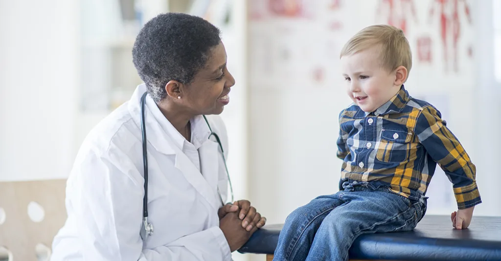 Nurse practitioner speaking to a child