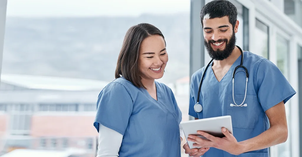 2 nurses looking at a tablet