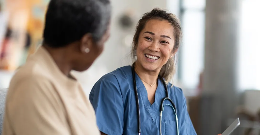 Nurse smiling talking to a patient