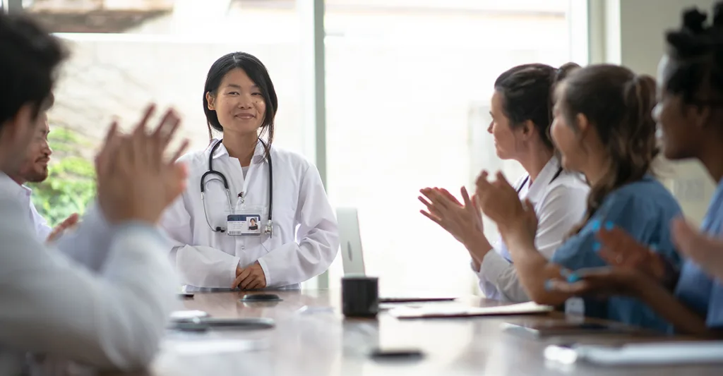 Staff clapping for nurse