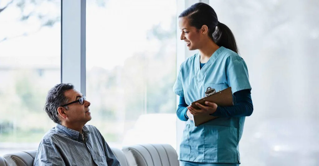 Nurse talking to patient in waiting room