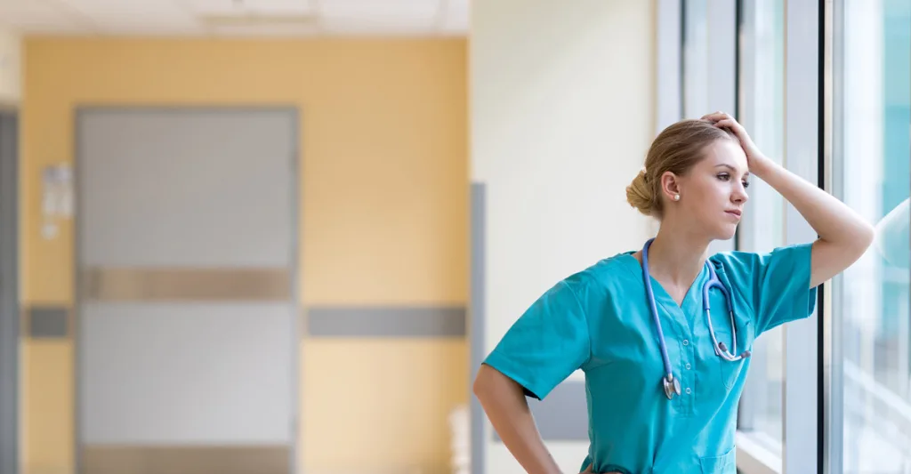 Stressed nurse looking out the window