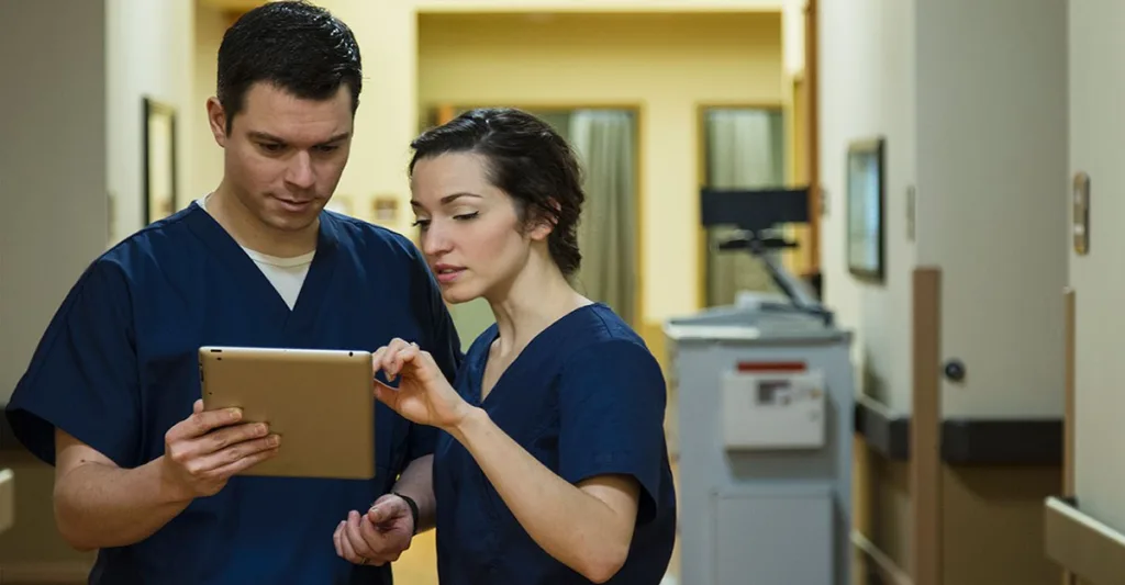 Two-nurses-talking-over-tablet-GettyImages-633707933-1.jpg