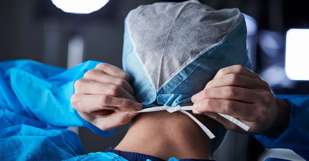 Nurse putting on a scrub cap