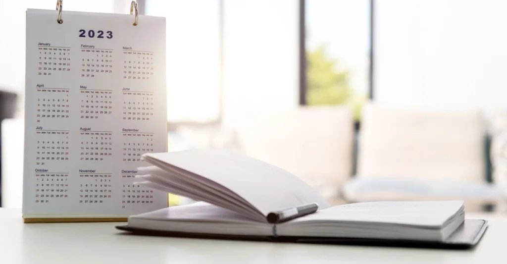 Calendar with an open book next to it