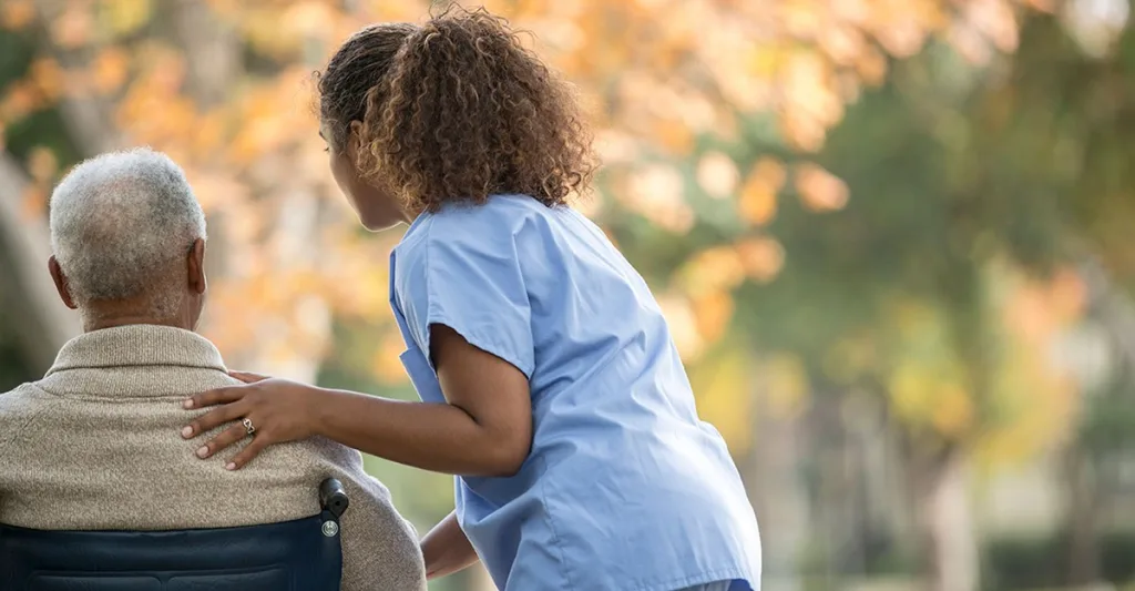 Nurse-with-patient-in-wheelchair-GettyImages-494327503.jpg