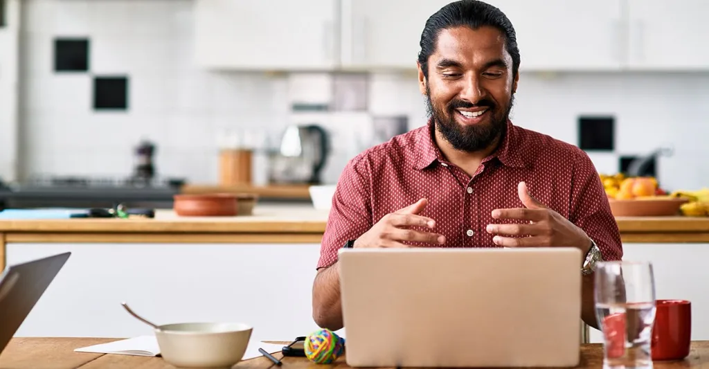 Man working from his kitchen on a laptop