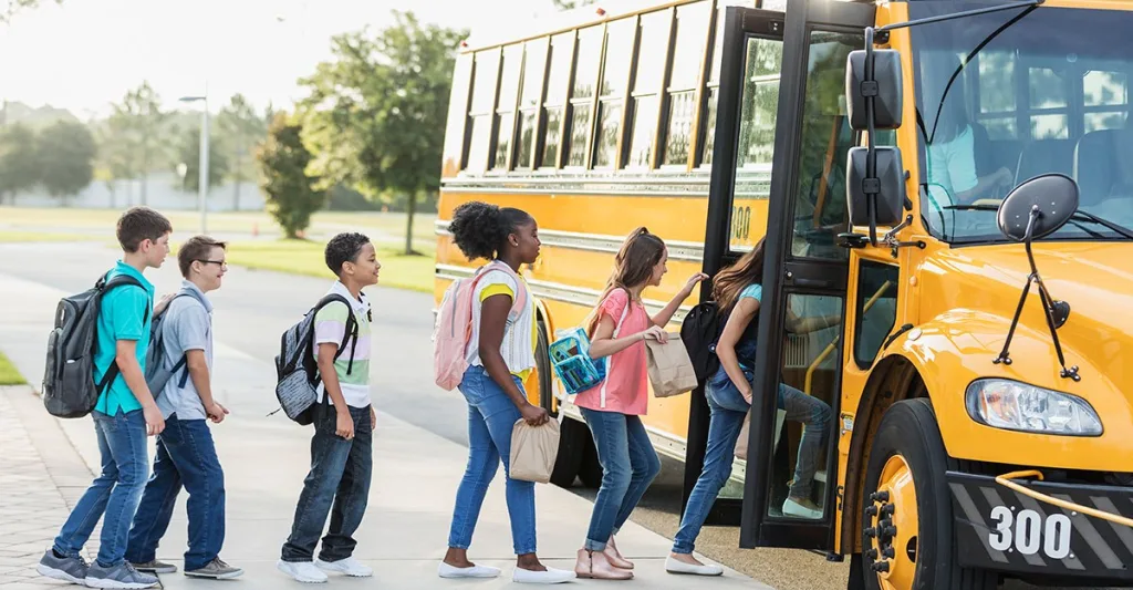 Children getting on a school bus