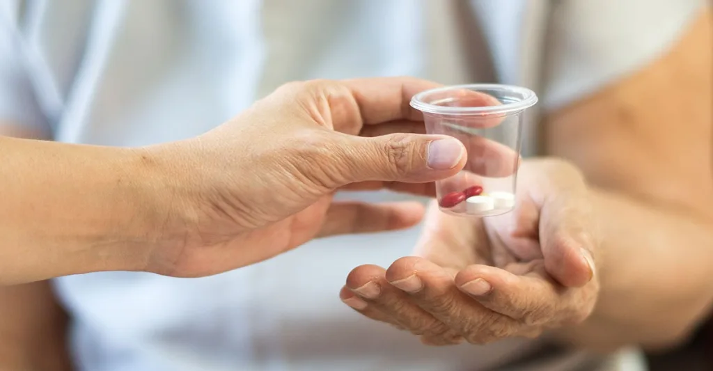 Nurse giving patient medication