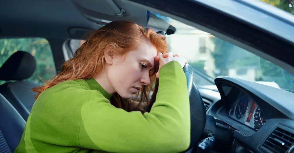 Upset woman in her car