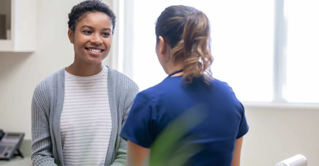 Nurse talking with female patient