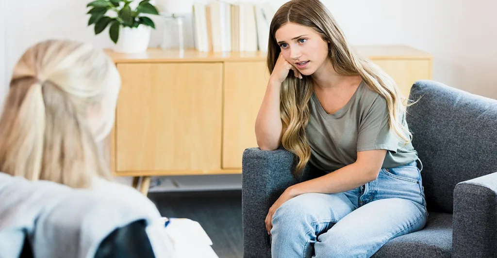 Teen girl with mental health counselor