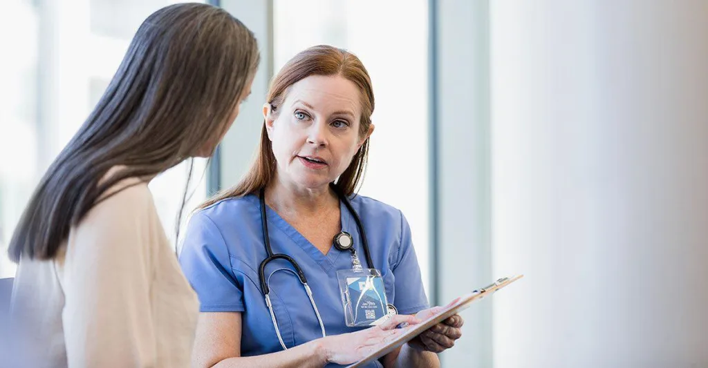 Nurse and woman having discussion