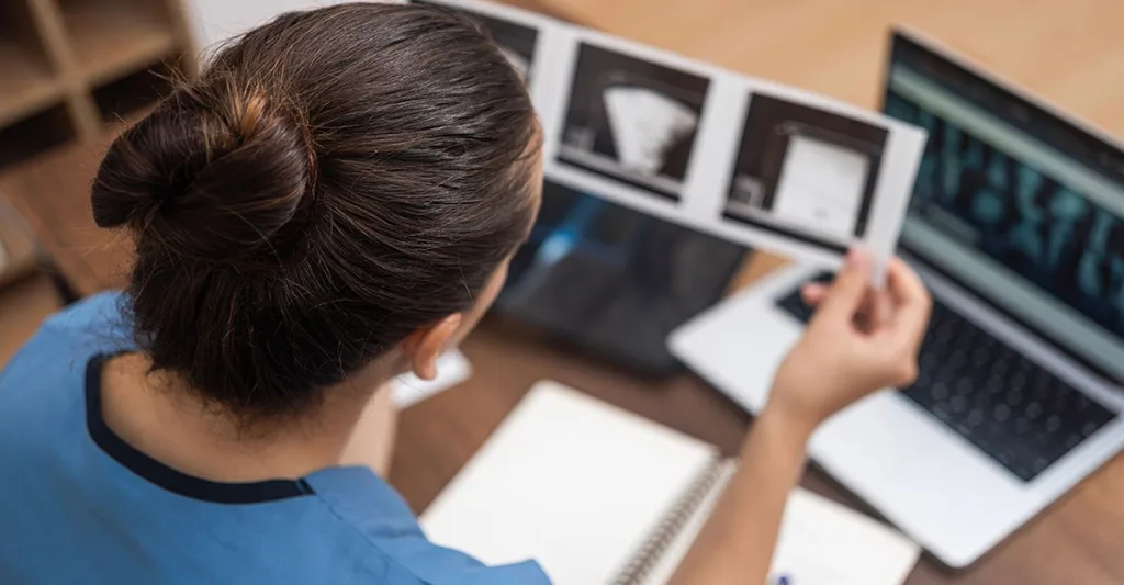 Nurse reviewing tests and charts