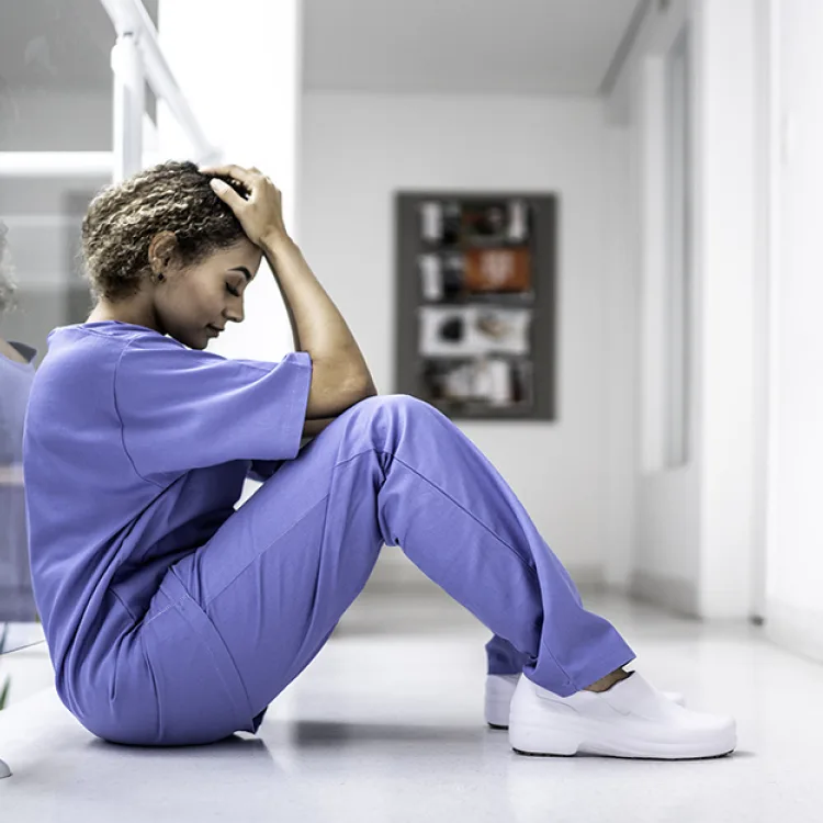 A nurse shows stress from burnout