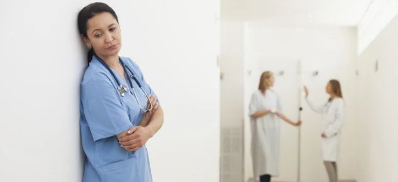 Nurse standing on the wall looking sad