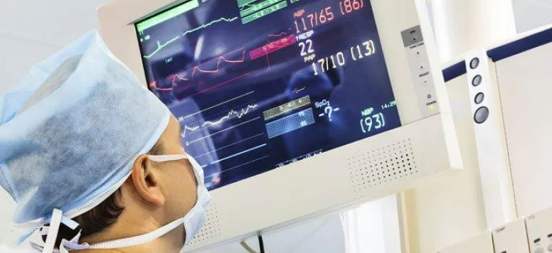 Nurse looking at vitals on a screen