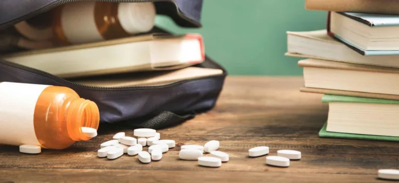 Pills falling out of a school backpack