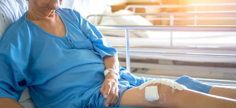 Women in hospital bed after knee surgery