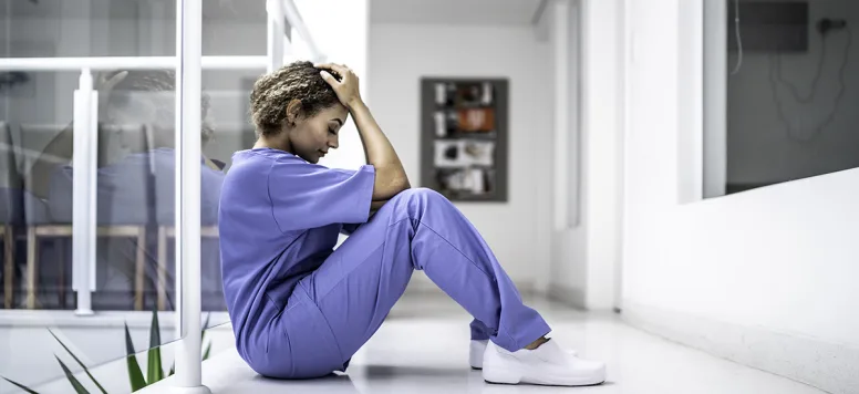 A nurse shows stress from burnout