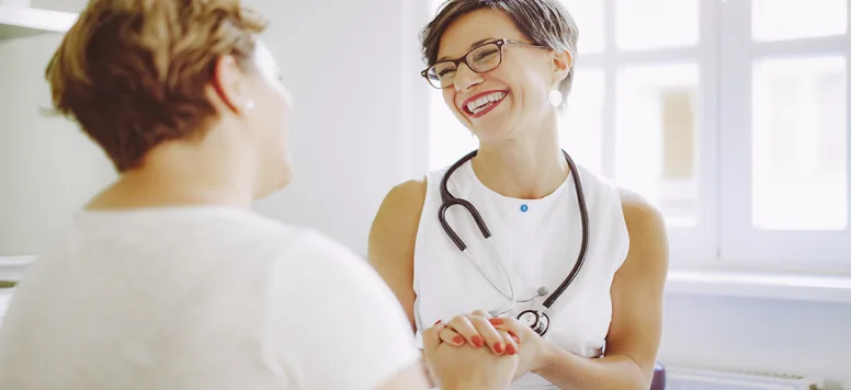 Nurse-with-stethoscope-laughing-with-patient-FB-GettyImages-589546152.jpg