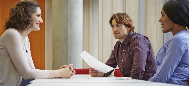 Three people in an interview