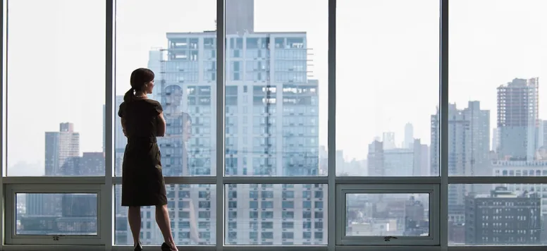 Business-woman-looking-out-window-GettyImages-90285062-web.jpg