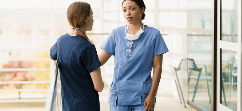 Two nurses standing outside talking