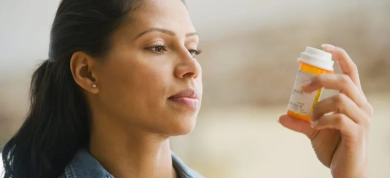 Woman-looking-at-prescription-bottle-GettyImages-74855020-scaled.jpg