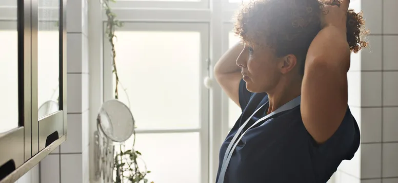 Nurse looking in mirror