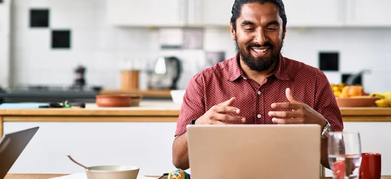 Man working from his kitchen on a laptop