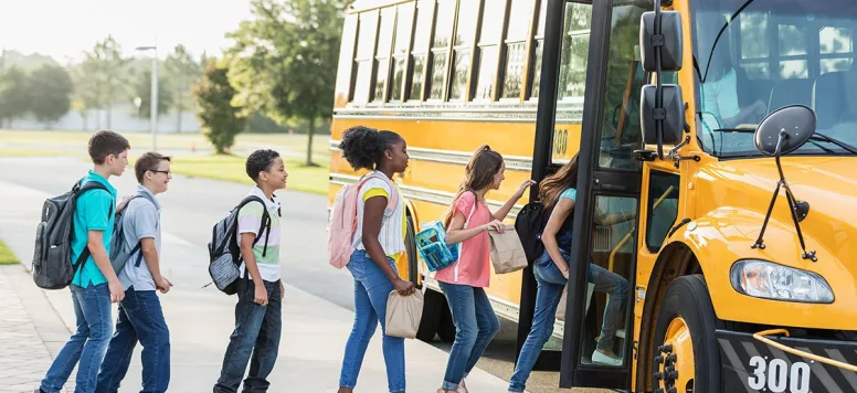 Children getting on a school bus