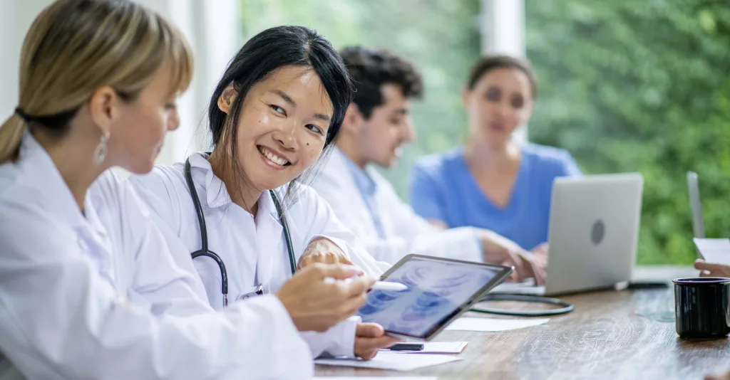 Nurses in a nurse residency program sitting at a table studying