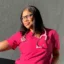 Portrait of a nurse in pink scrubs wearing a stethoscope