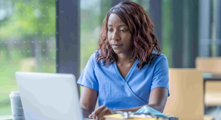 Nurse working on a computer on her online certification