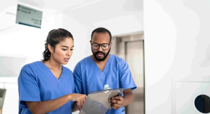 Two nurses reviewing a chart