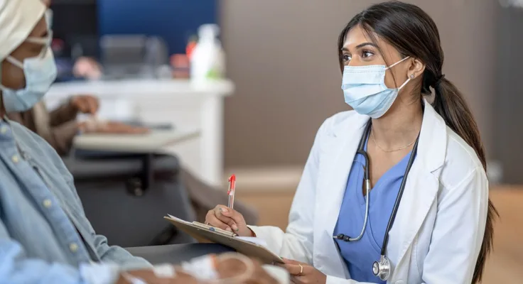 Oncology nurse helping a patient during a clinical trial