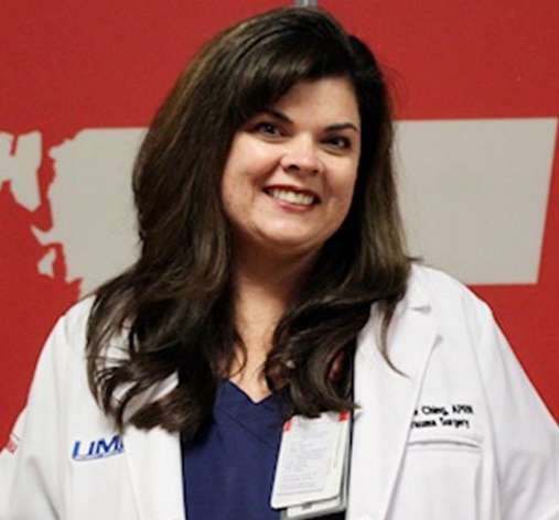 Photo of woman smiling wearing white labcoat