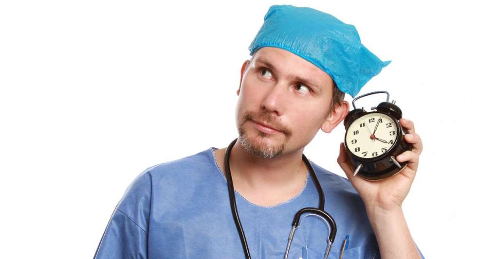 Nurse listening to a clock