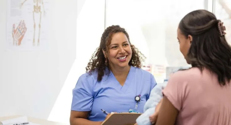 Nurse talking with patient in doctors office