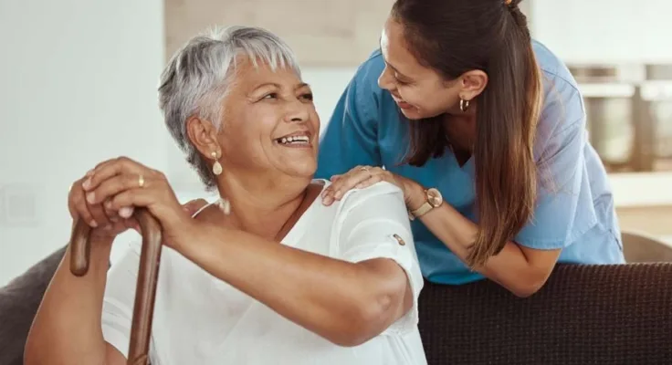 Nurse comforting patient sitting on couch