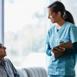 Nurse talking to patient in waiting room