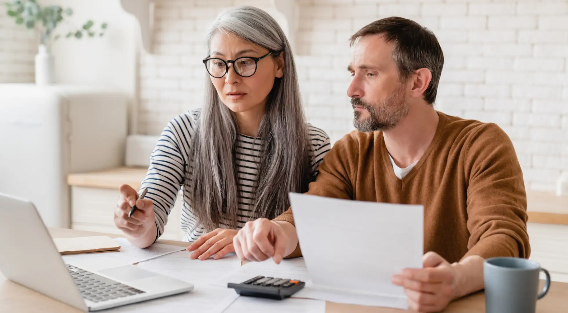 A mature couple reviewing FHA mortgage insurance premiums.